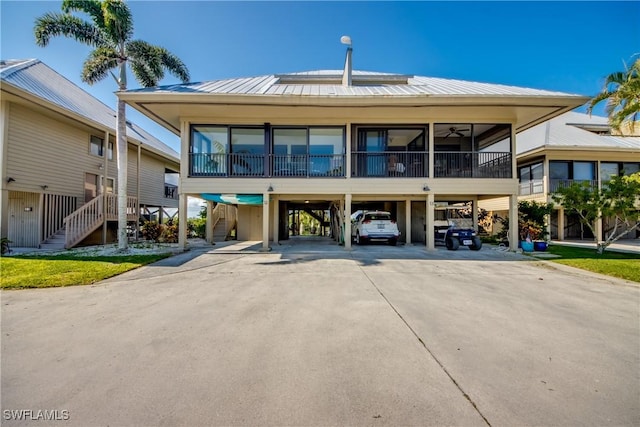 exterior space featuring driveway, stairs, and a carport