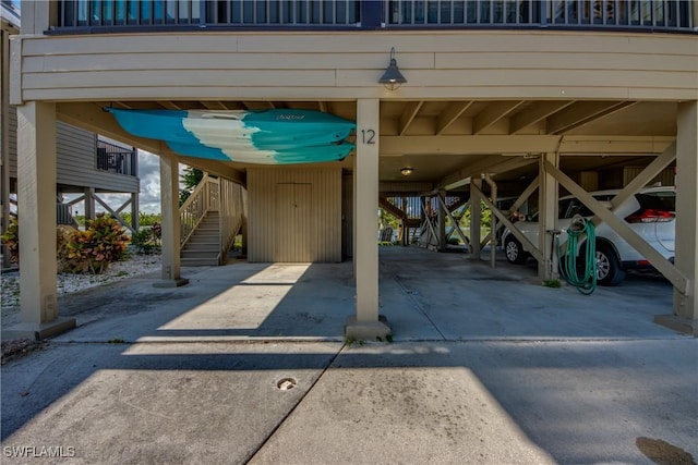 view of parking / parking lot with stairs and a carport