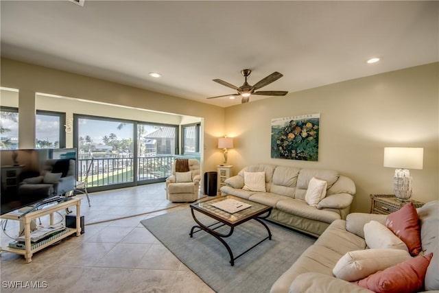 living area with recessed lighting, a ceiling fan, and light tile patterned flooring