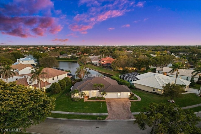 drone / aerial view featuring a residential view and a water view