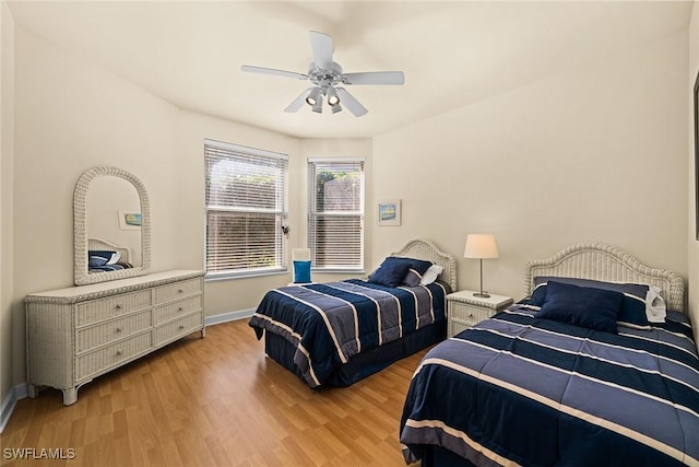 bedroom featuring light wood-style floors, ceiling fan, and baseboards