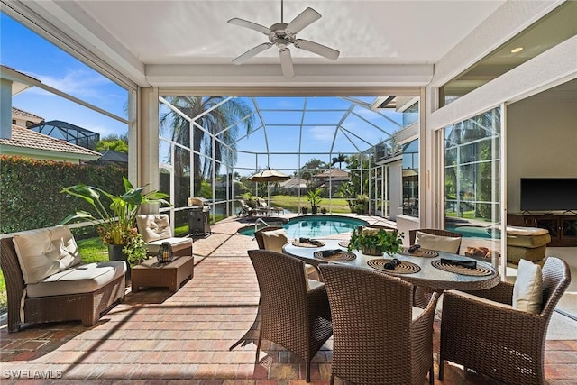 sunroom featuring a ceiling fan