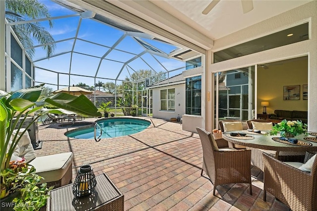 outdoor pool featuring a lanai, ceiling fan, outdoor dining area, and a patio