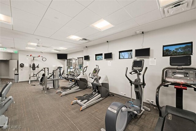 exercise room featuring carpet, visible vents, and a paneled ceiling