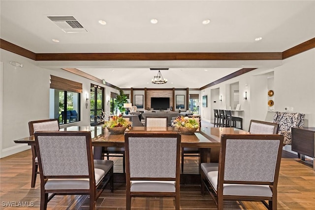 dining room with baseboards, visible vents, wood finished floors, a chandelier, and recessed lighting