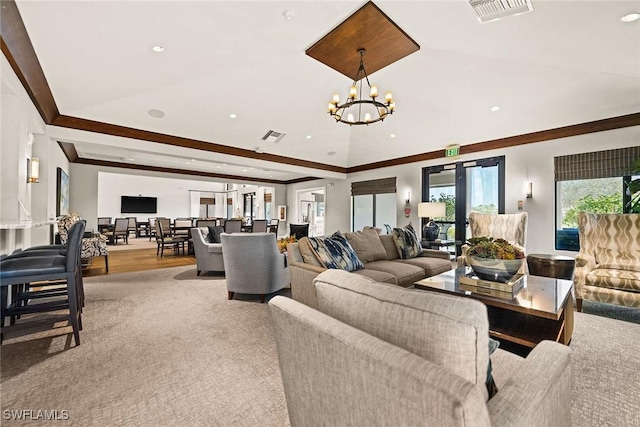 living area with crown molding, recessed lighting, visible vents, and an inviting chandelier