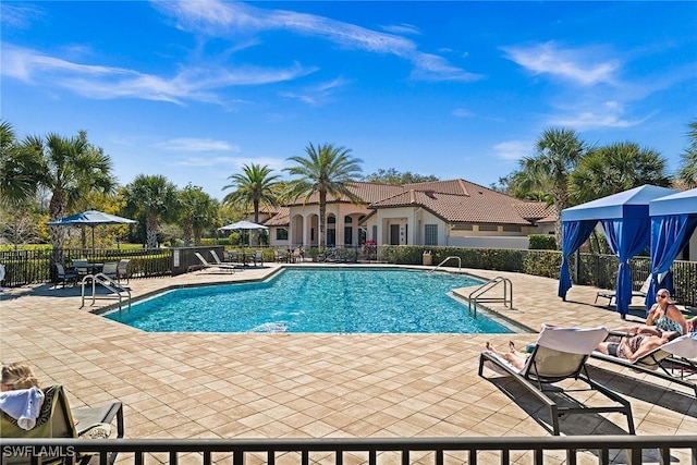 pool featuring a patio area and fence