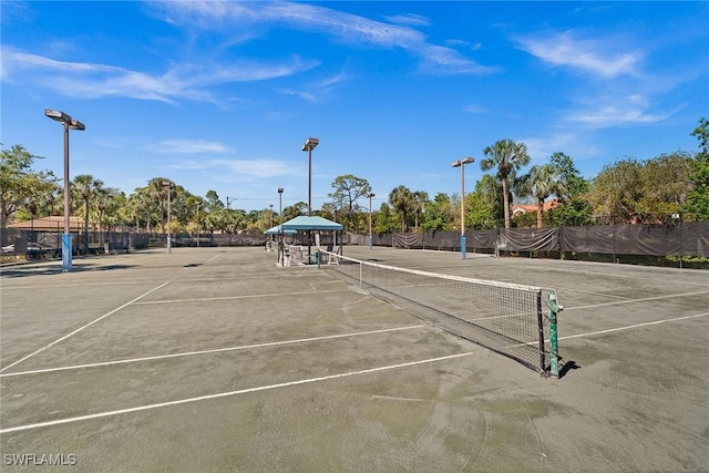 view of tennis court with fence