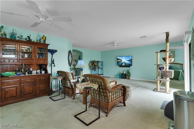 living room featuring a ceiling fan and light colored carpet