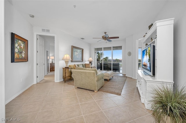 living room with light tile patterned floors, ceiling fan, visible vents, and baseboards