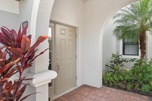 property entrance featuring stucco siding