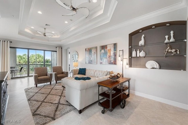 tiled living room featuring baseboards, visible vents, ceiling fan, a tray ceiling, and crown molding