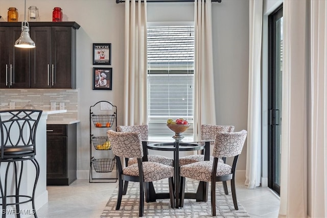 dining area featuring light tile patterned floors and baseboards