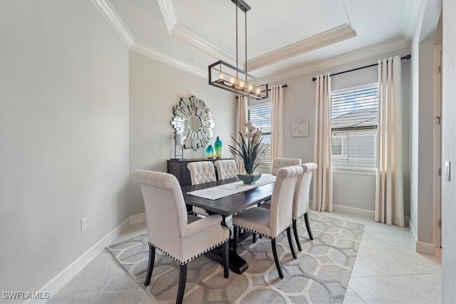 dining space featuring baseboards, light tile patterned flooring, a raised ceiling, and crown molding