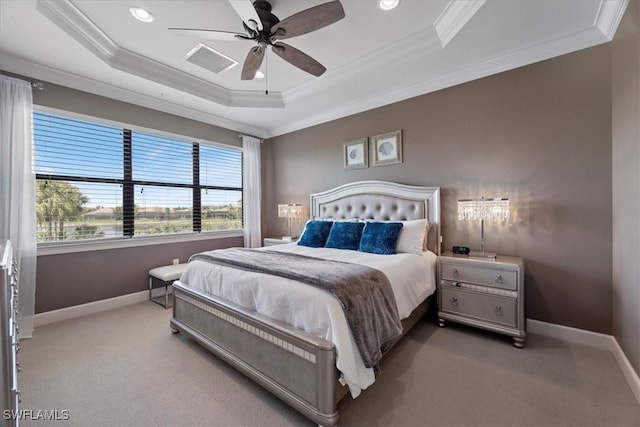 bedroom with carpet floors, a tray ceiling, crown molding, and baseboards