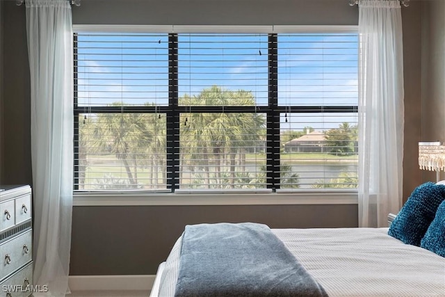 bedroom with multiple windows and baseboards