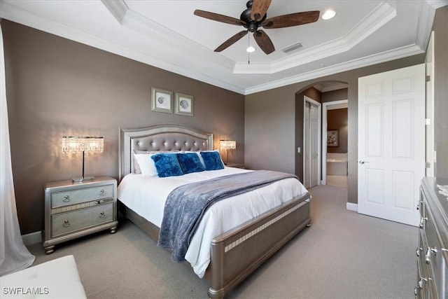 bedroom with arched walkways, a raised ceiling, and visible vents