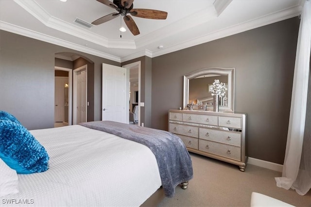 bedroom featuring arched walkways, carpet floors, visible vents, baseboards, and a raised ceiling