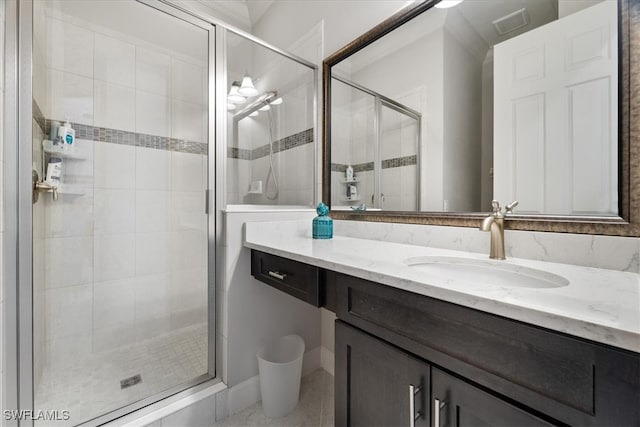 bathroom featuring a shower stall and vanity