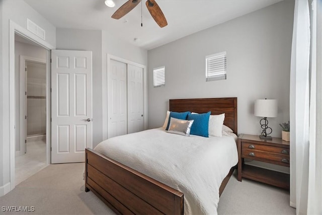 bedroom featuring a ceiling fan, a closet, light colored carpet, and visible vents