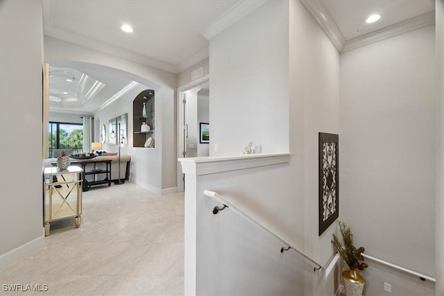 hall with baseboards, visible vents, arched walkways, ornamental molding, and recessed lighting