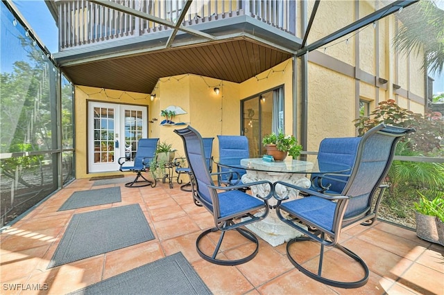 view of patio / terrace with french doors, outdoor dining space, and a balcony