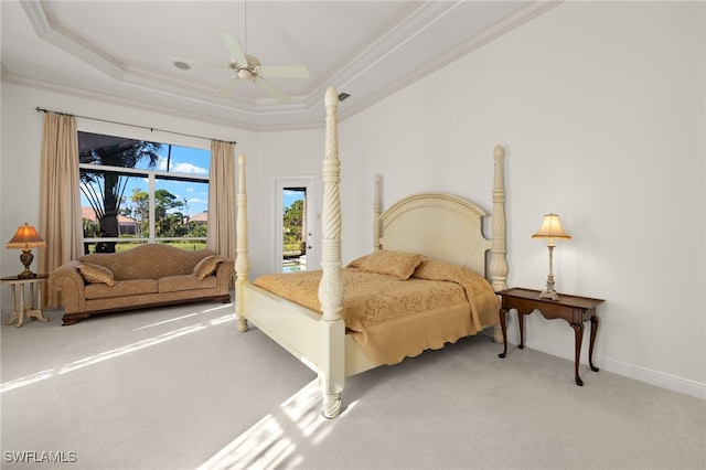 bedroom featuring carpet, a tray ceiling, ceiling fan, access to exterior, and crown molding