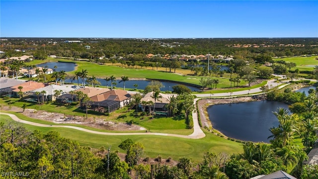 birds eye view of property with view of golf course and a water view