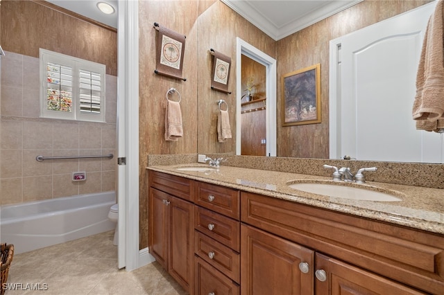 bathroom featuring tile patterned floors, ornamental molding, toilet, and a sink