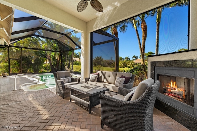 view of patio with an outdoor pool, a lanai, and an outdoor living space with a fireplace