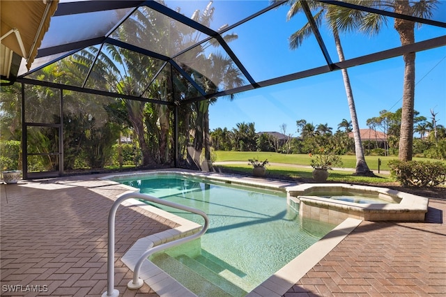 view of pool featuring a patio, a yard, a pool with connected hot tub, and a lanai