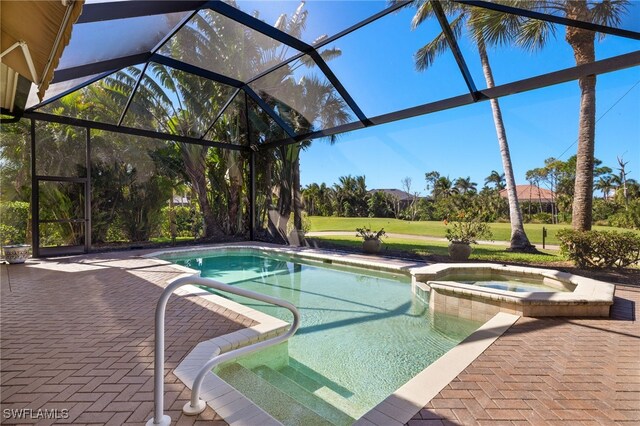 18270 Creekside View Dr, Fort Myers, FL 33908 - view of pool featuring glass enclosure, a patio area, a lawn, and a pool with connected hot tub