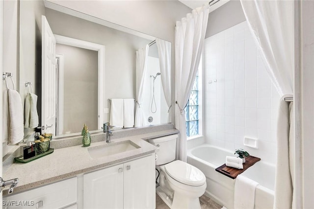 bathroom featuring shower / bath combo, vanity, and toilet