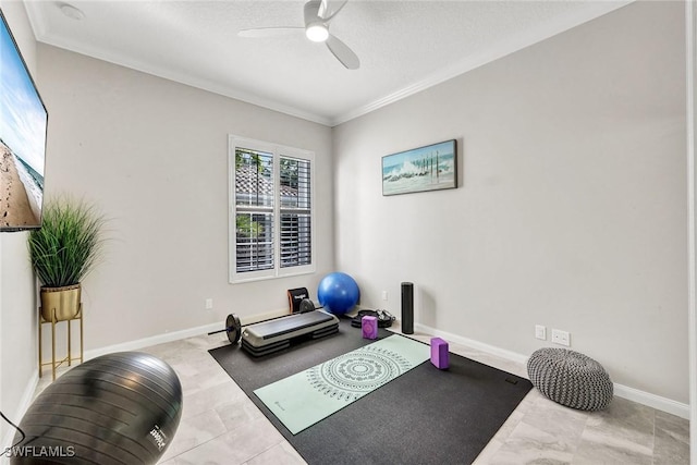 workout area featuring ceiling fan, crown molding, and baseboards