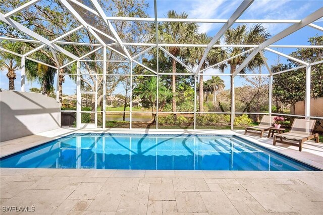 pool featuring a patio and glass enclosure