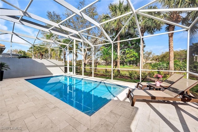 view of pool with a patio, glass enclosure, and a fenced in pool