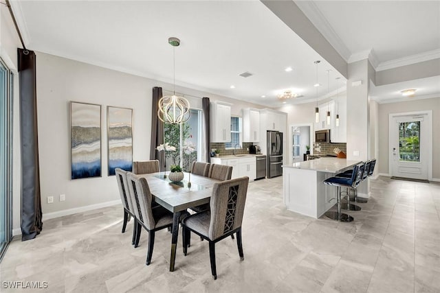 dining room with visible vents, crown molding, and baseboards