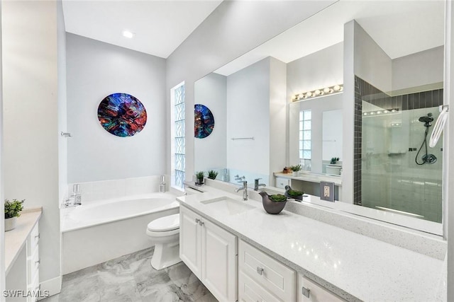 bathroom with a shower stall, vanity, and a bath