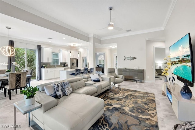 living area with ceiling fan, marble finish floor, baseboards, and crown molding