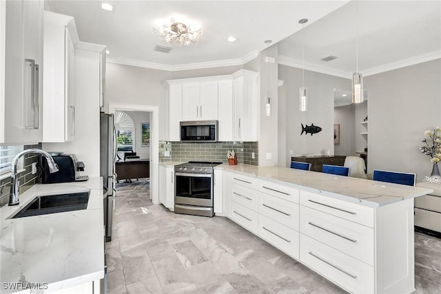 kitchen featuring a peninsula, appliances with stainless steel finishes, visible vents, and white cabinetry