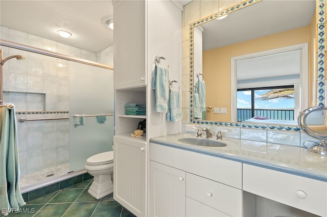 full bath featuring vanity, tile patterned floors, toilet, and a stall shower