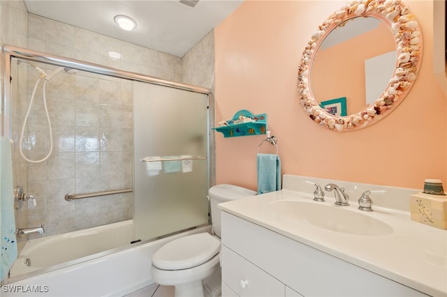 full bathroom with vanity, toilet, and shower / bath combination with glass door