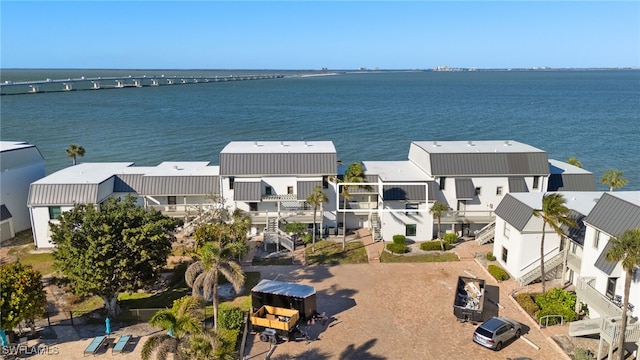 drone / aerial view with a residential view and a water view