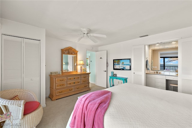 carpeted bedroom with visible vents, a closet, ceiling fan, and built in desk