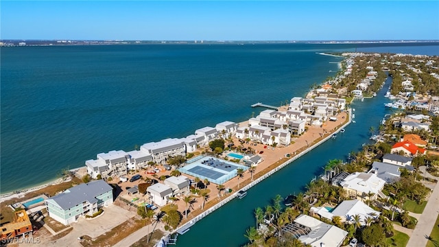 drone / aerial view with a residential view and a water view