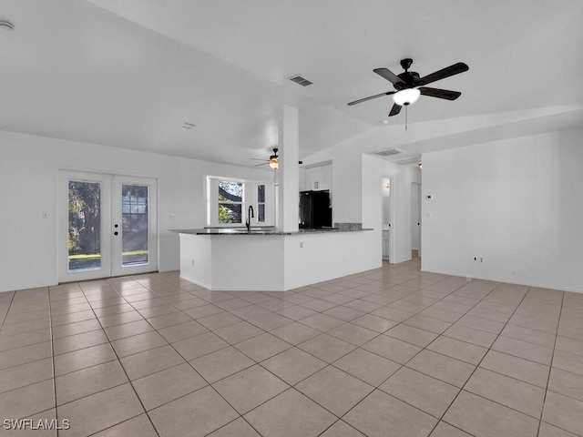 unfurnished living room featuring visible vents, a sink, french doors, light tile patterned floors, and ceiling fan