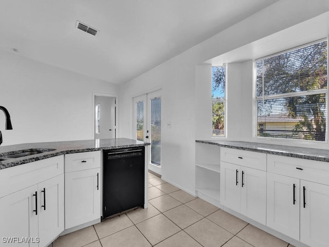 kitchen featuring visible vents, a sink, black dishwasher, white cabinetry, and dark stone counters