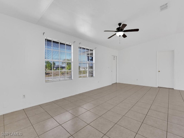 unfurnished room with light tile patterned flooring, visible vents, and ceiling fan