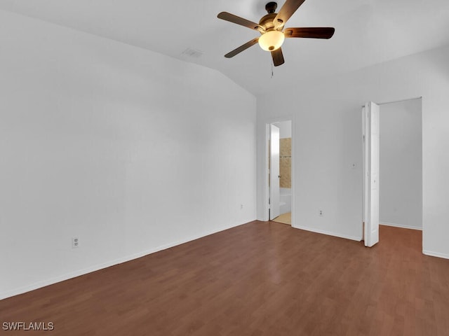 empty room with baseboards, a ceiling fan, lofted ceiling, and wood finished floors