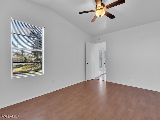 unfurnished room with baseboards, a ceiling fan, lofted ceiling, and wood finished floors